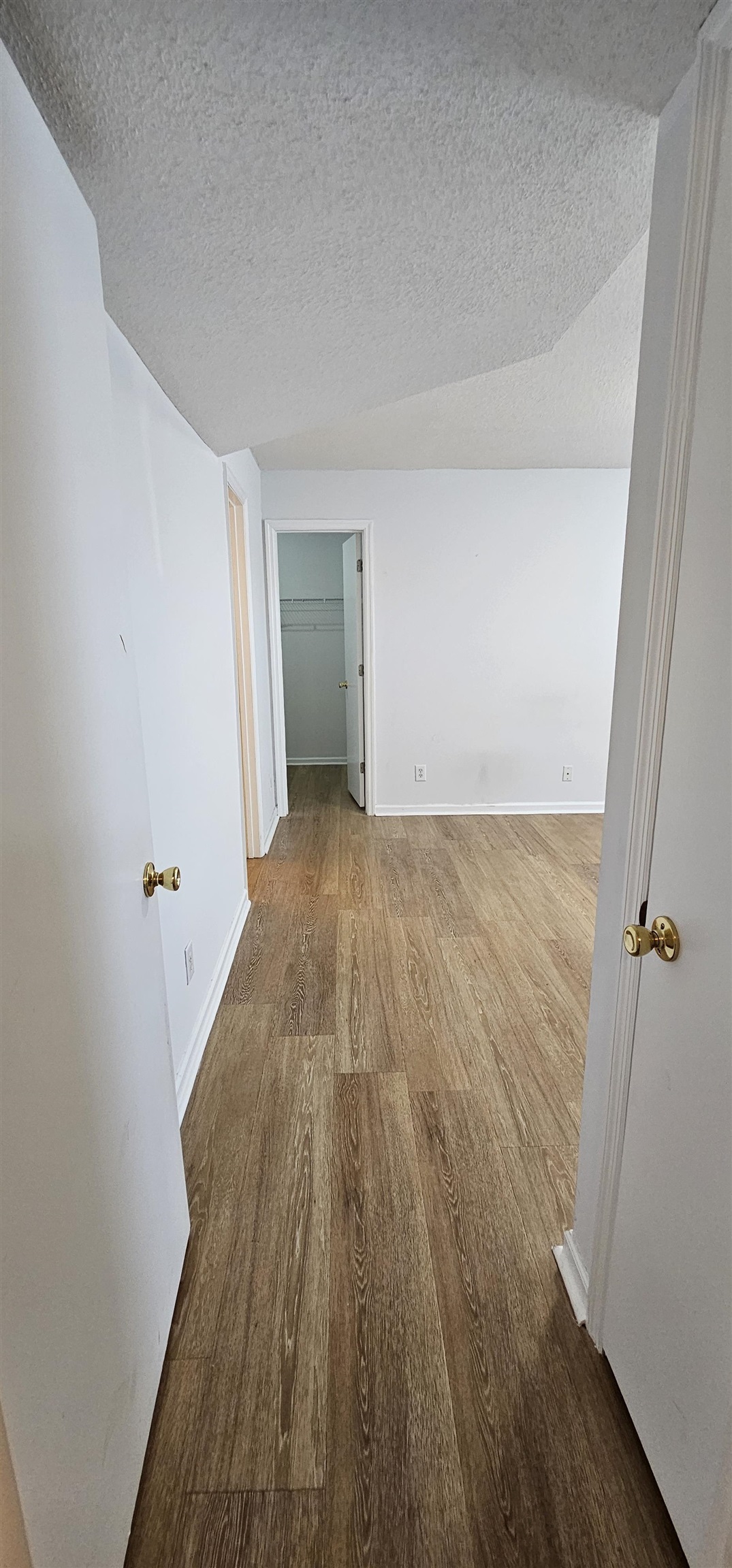 2273 Huntingdon Drive, Unit J Myrtle Beach, SC 29575 - Photo 12 of 24 Unfurnished room featuring dark wood-style flooring and a textured ceiling