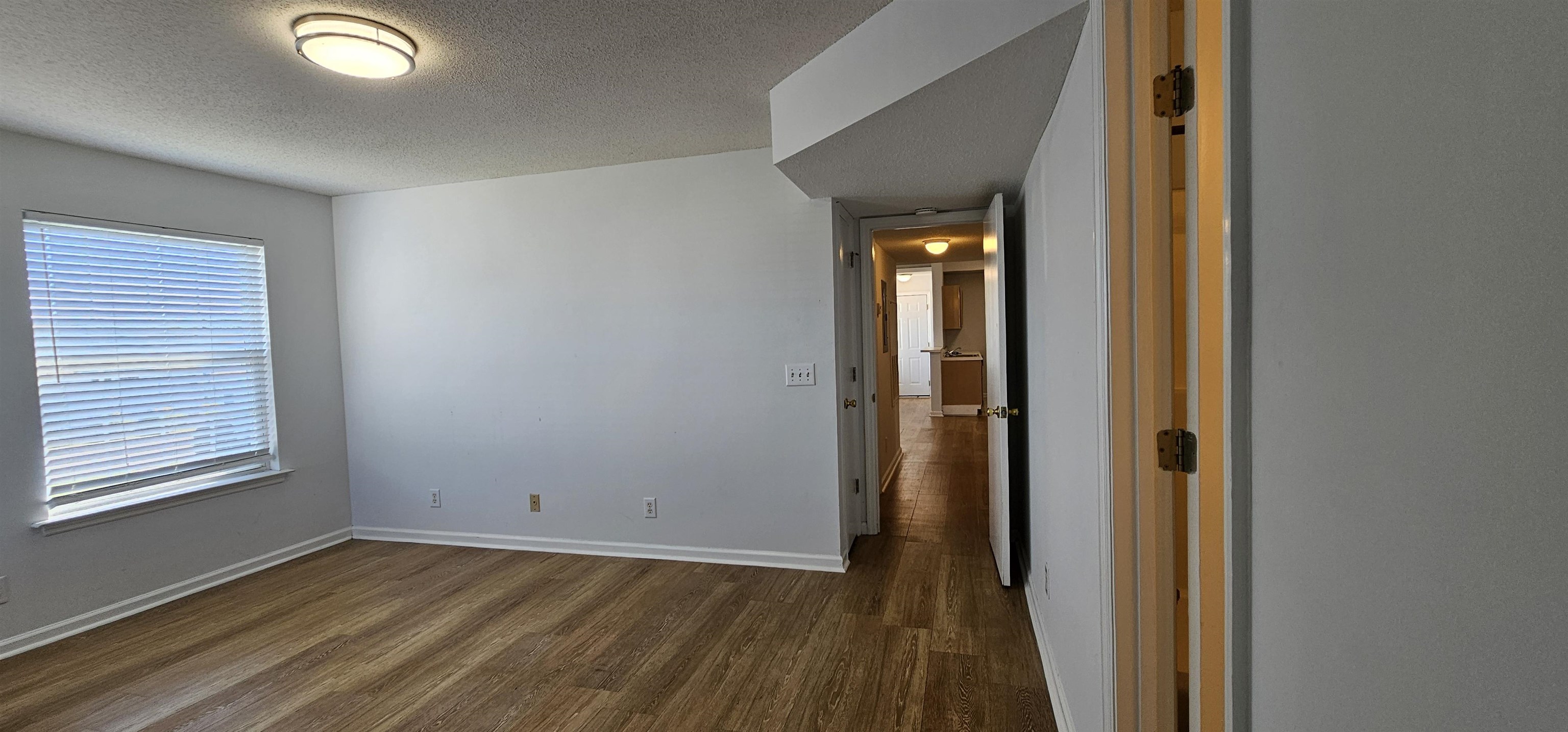 2273 Huntingdon Drive, Unit J Myrtle Beach, SC 29575 - Photo 14 of 24 Unfurnished room with a textured ceiling and dark wood-type flooring