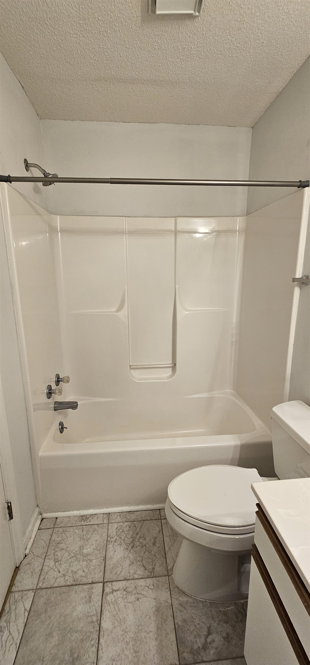 2273 Huntingdon Drive, Unit J Myrtle Beach, SC 29575 - Photo 22 of 24 Full bath featuring shower combination, a textured ceiling, and vanity