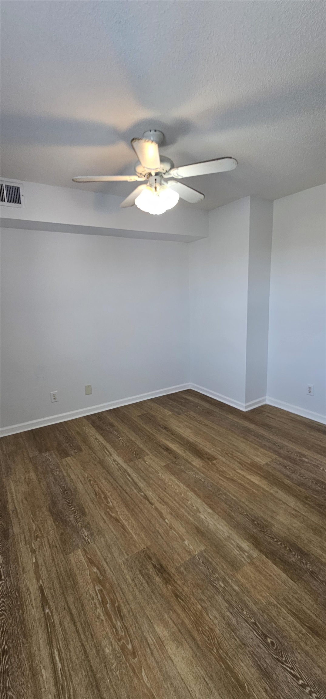 2273 Huntingdon Drive, Unit J Myrtle Beach, SC 29575 - Photo 23 of 24 Unfurnished room with a ceiling fan, a textured ceiling, and dark wood-style floors