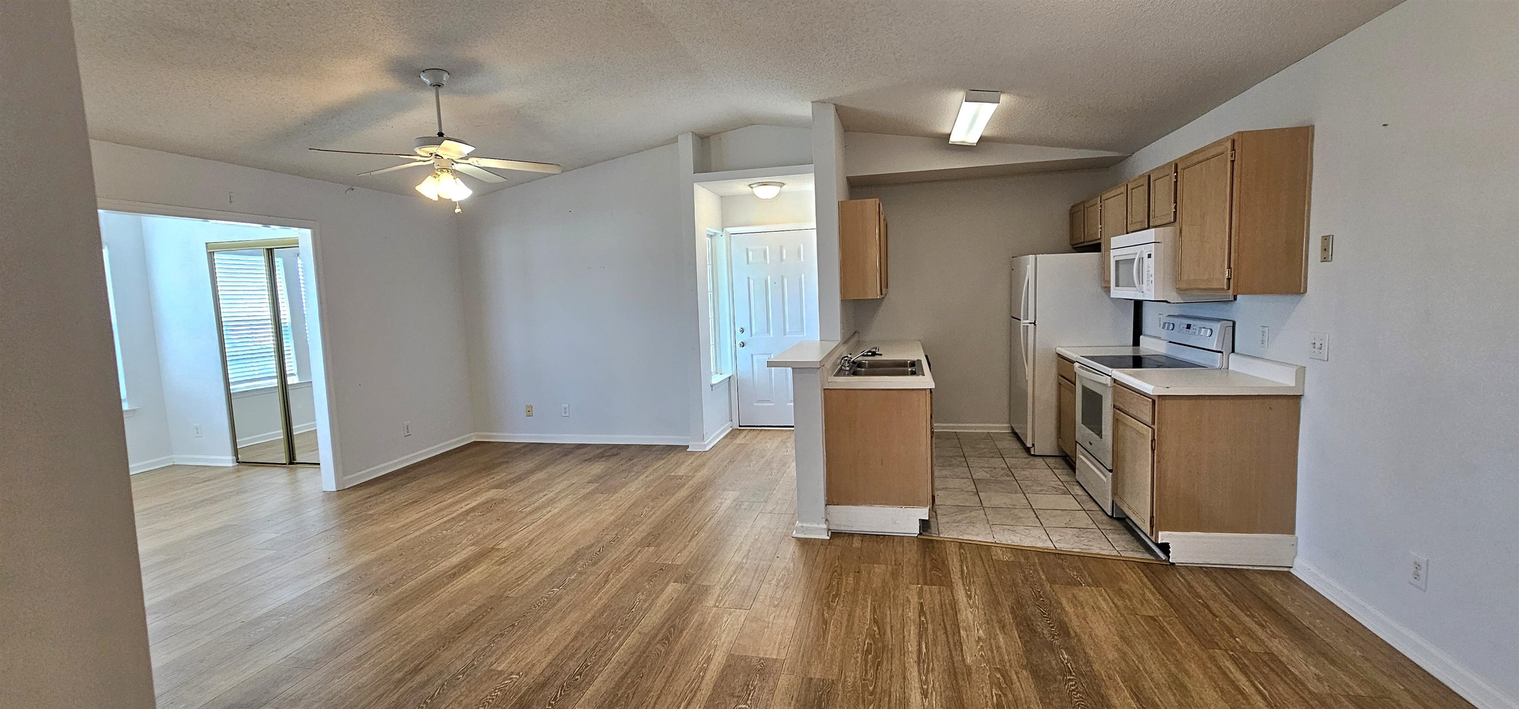 2273 Huntingdon Drive, Unit J Myrtle Beach, SC 29575 - Photo 6 of 24 Kitchen featuring light countertops, white appliances, a textured ceiling, ceiling fan, and light wood-type flooring