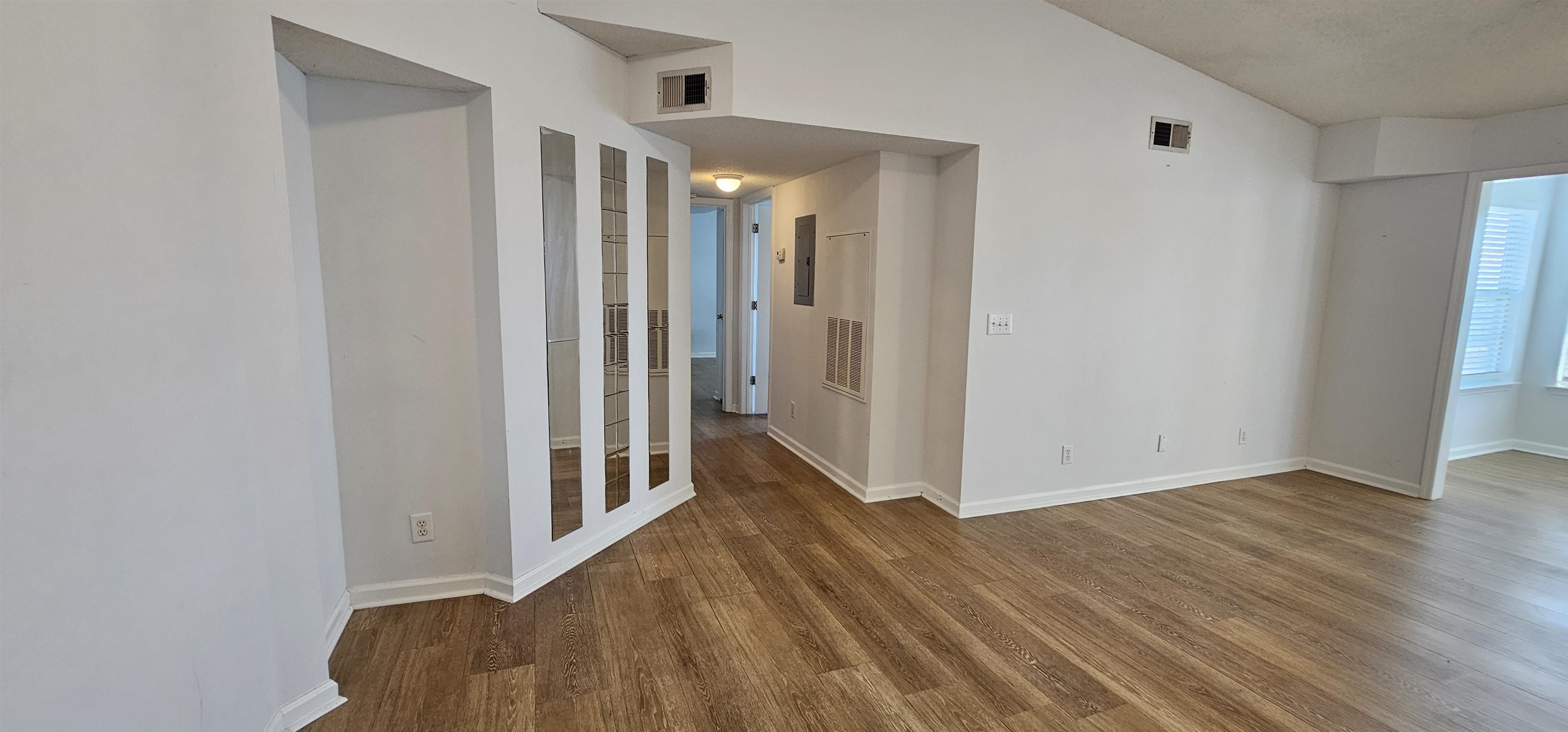 2273 Huntingdon Drive, Unit J Myrtle Beach, SC 29575 - Photo 9 of 24 Spare room featuring wood finished floors, lofted ceiling, and electric panel