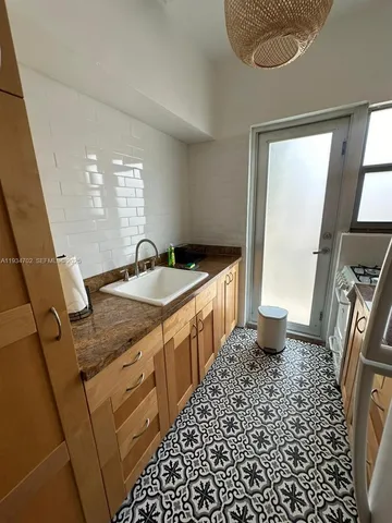 a spacious bathroom with a granite countertop sink and a mirror