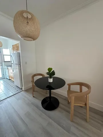 a view of a livingroom with furniture and a potted plant