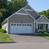 a view of a house with a yard and a garden