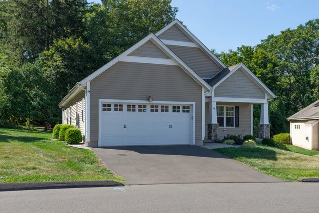 a view of a house with a yard and a garden