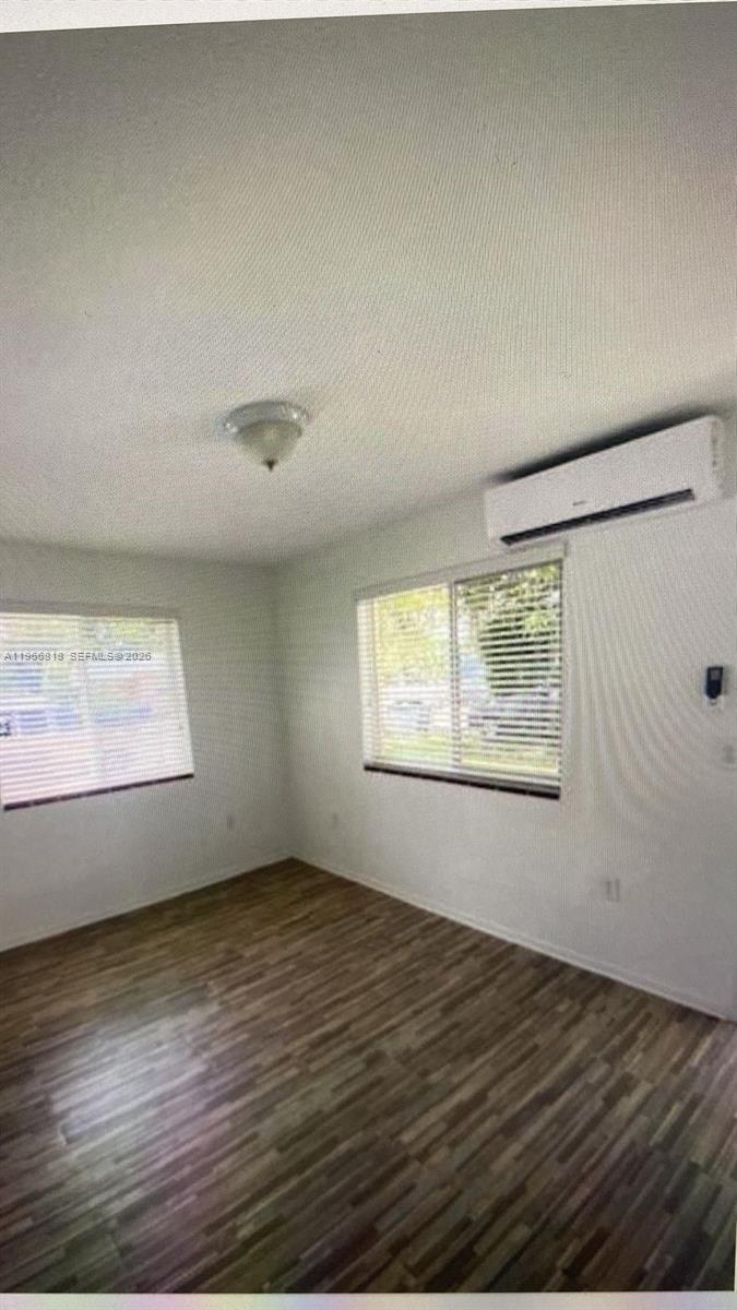 7637 Northwest 3rd Avenue, Unit 1 Miami, FL 33150 - Photo 11 of 20 an empty room with wooden floor and windows