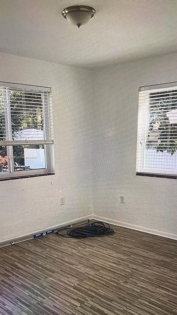 7637 Northwest 3rd Avenue, Unit 1 Miami, FL 33150 - Photo 12 of 20 a view of a room with wooden floor and window
