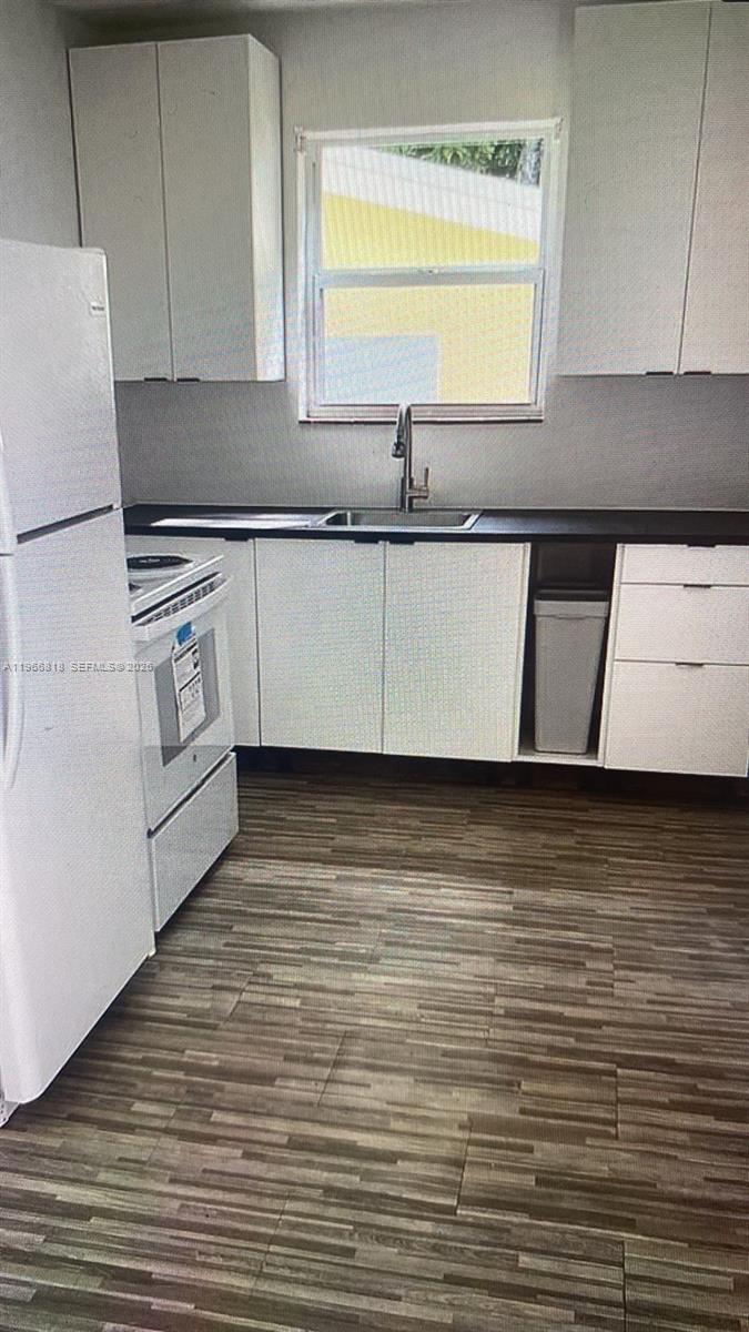 7637 Northwest 3rd Avenue, Unit 1 Miami, FL 33150 - Photo 15 of 20 a kitchen with stainless steel appliances granite countertop a sink a stove and a refrigerator