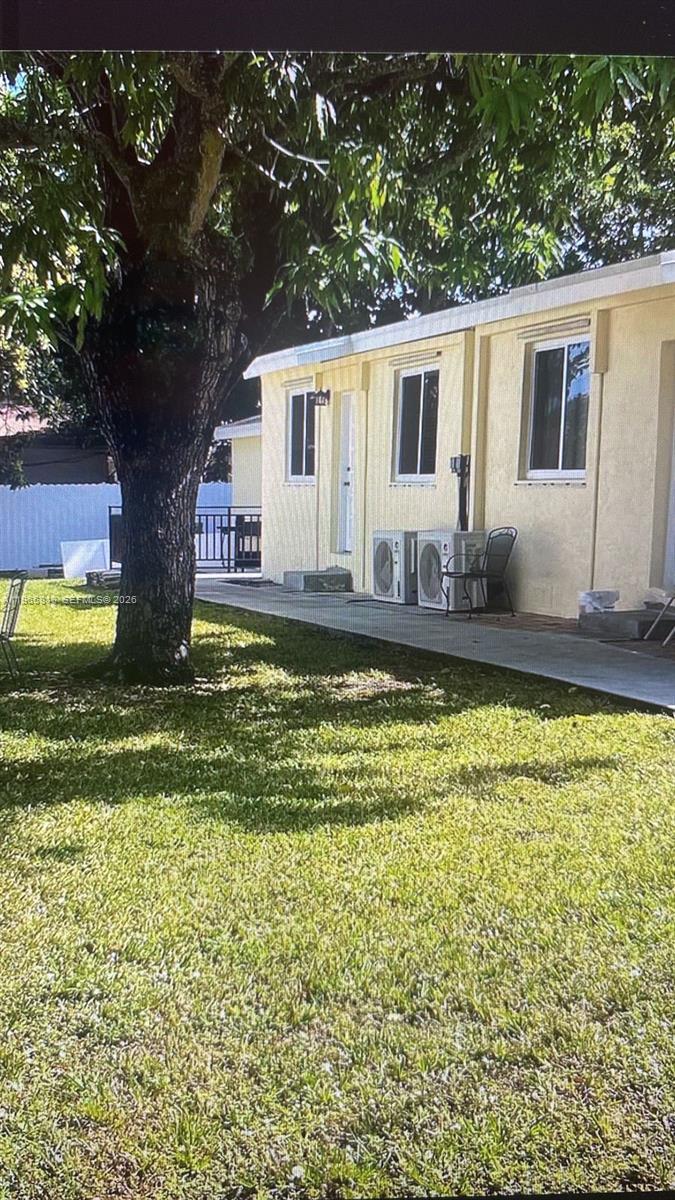 7637 Northwest 3rd Avenue, Unit 1 Miami, FL 33150 - Photo 18 of 20 a view of a house with swimming pool and a yard