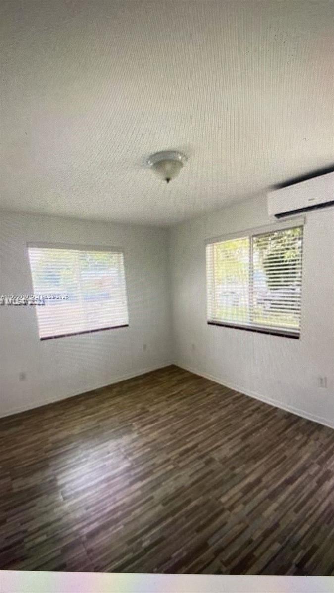 7637 Northwest 3rd Avenue, Unit 1 Miami, FL 33150 - Photo 4 of 20 an empty room with wooden floor and windows