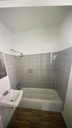 a bathroom with a bathtub and shower