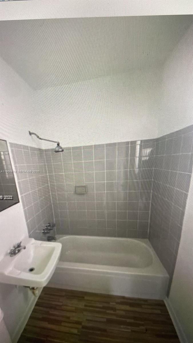7637 Northwest 3rd Avenue, Unit 1 Miami, FL 33150 - Photo 8 of 20 a bathroom with a bathtub and shower