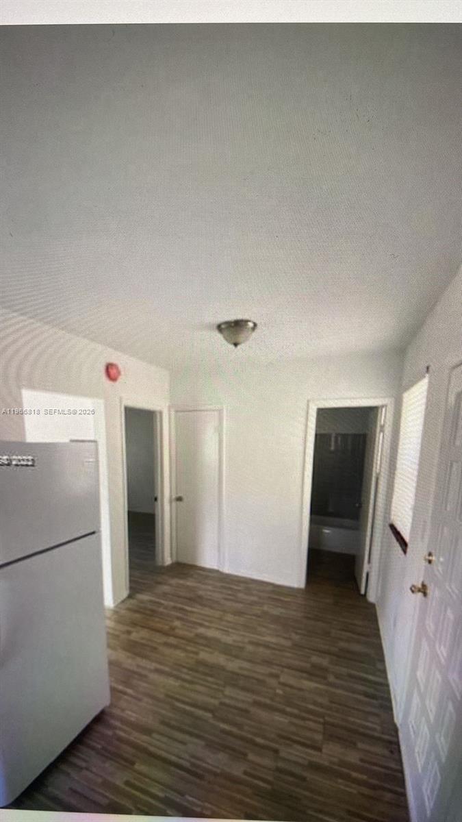 7637 Northwest 3rd Avenue, Unit 1 Miami, FL 33150 - Photo 9 of 20 a view of a refrigerator in kitchen and wooden floor
