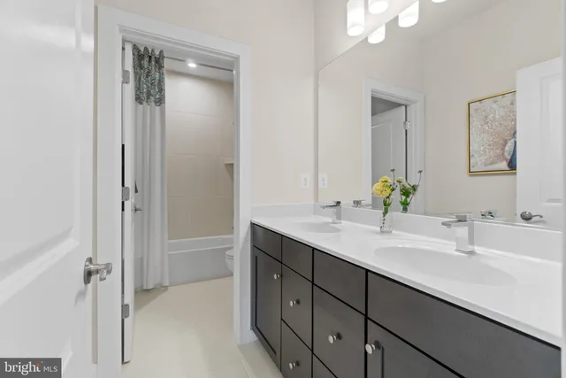 a bathroom with a double vanity sink and a mirror