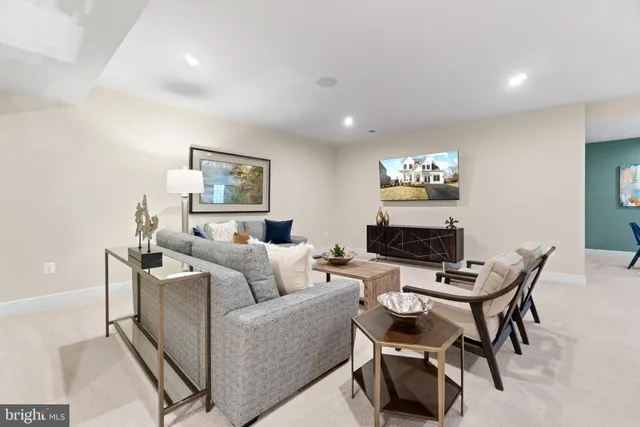 a living room with furniture a flat screen tv and a wall