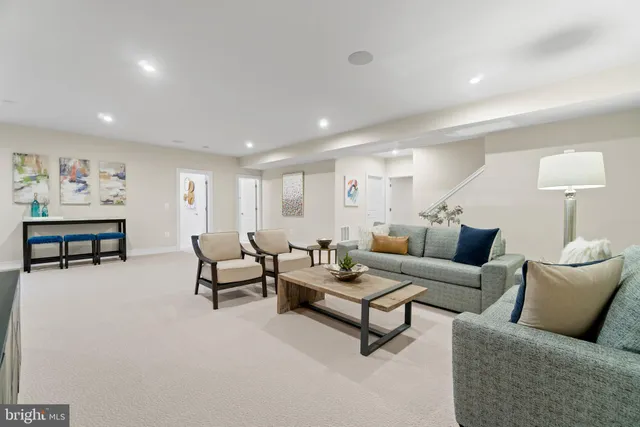 a living room with furniture and a lamp