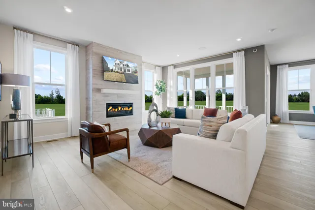 a living room with fireplace furniture and a wooden floor