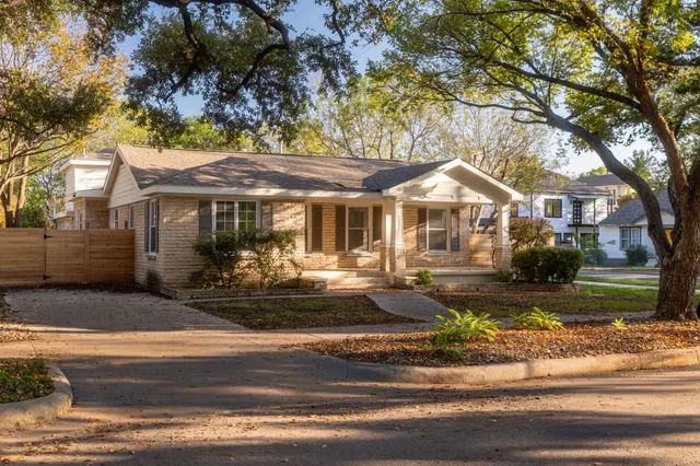 a front view of a house with yard porch and outdoor seating