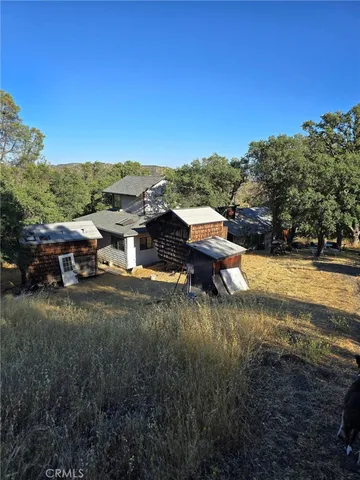 a view of house with outdoor space and garden