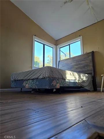 a living room with a bed furniture and a window
