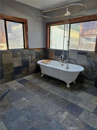 a spacious bathroom with a sink and a mirror
