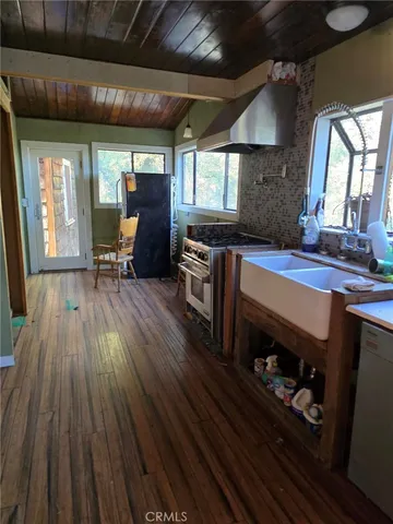 a kitchen with wooden floors and a stove