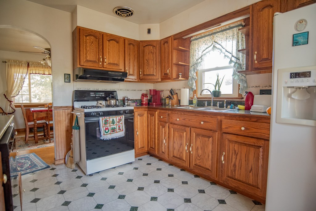 469 Terwilliger Road Parker, PA 16049 - Photo 18 of 47 a kitchen with stainless steel appliances granite countertop a stove a sink dishwasher and a microwave oven with cabinets