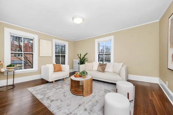 a living room with furniture and wooden floor