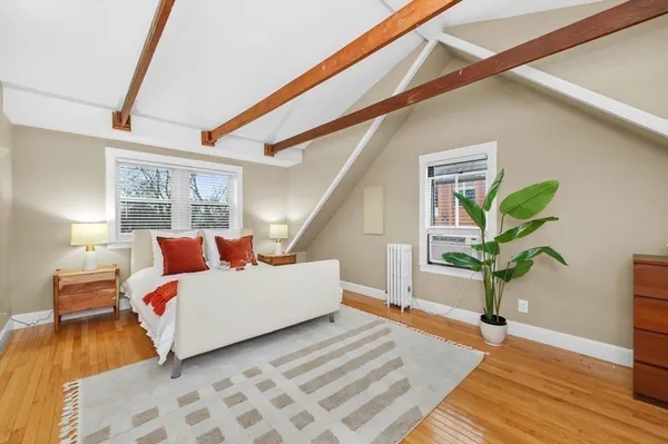a bedroom with a bed and a potted plant