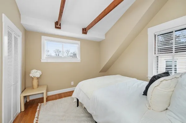 a bedroom with a bed and a potted plant