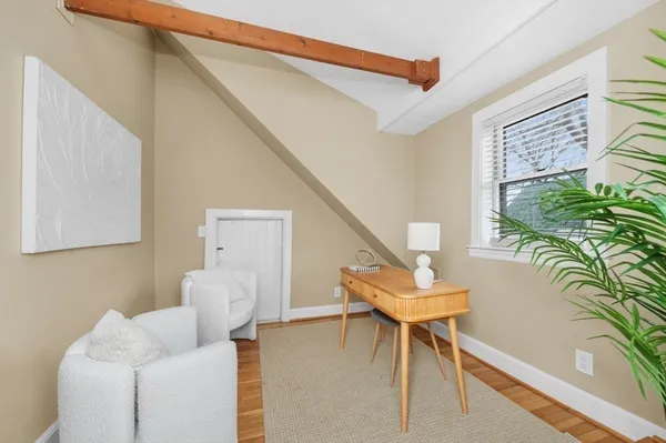 a living room with furniture and a potted plant