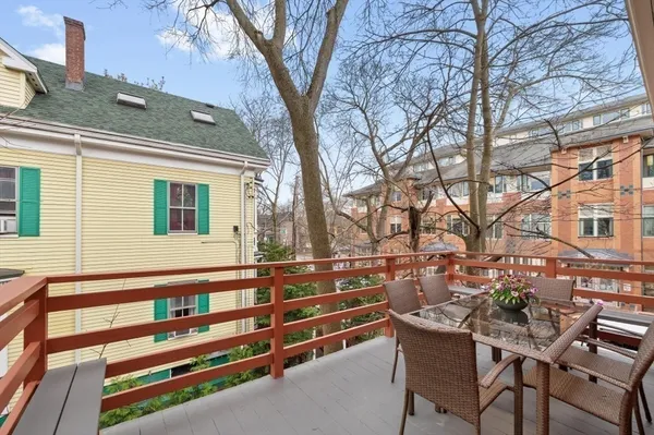 a view of a chairs and table in the back yard