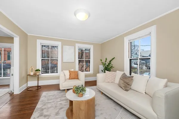 a living room with furniture and wooden floor