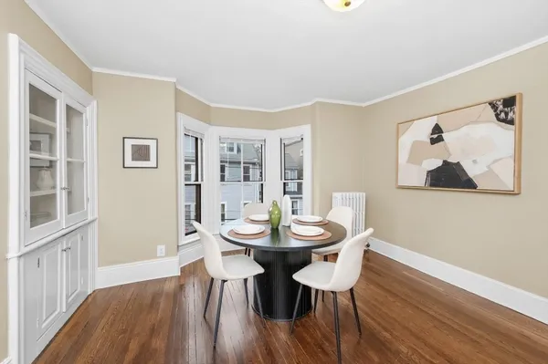 a view of a dining room with furniture and wooden floor