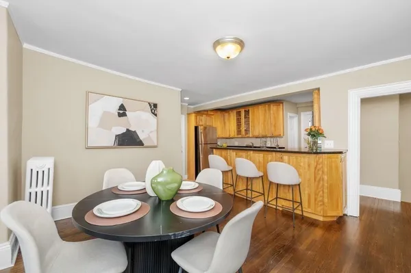 a view of a dining room with furniture and wooden floor