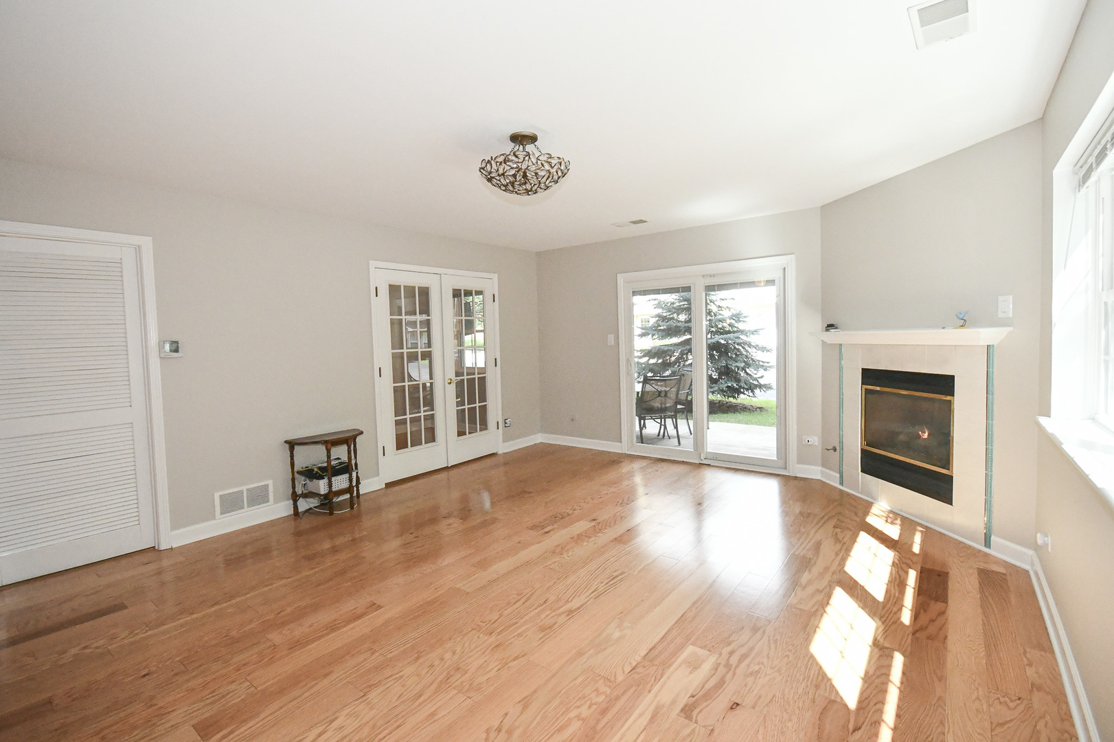 960 Elderberry Circle, Unit 108 Naperville, IL 60563 - Photo 15 of 32 a view of an empty room with wooden floor and a window