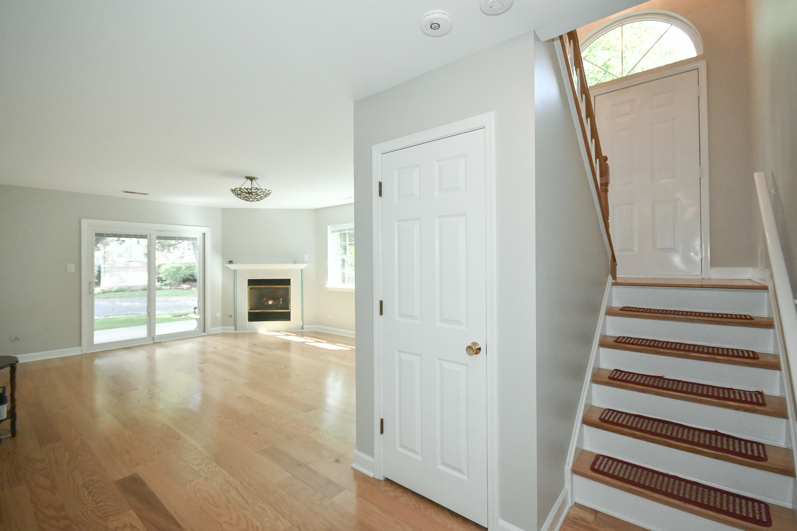 960 Elderberry Circle, Unit 108 Naperville, IL 60563 - Photo 17 of 32 a view of a livingroom with wooden floor and a fireplace