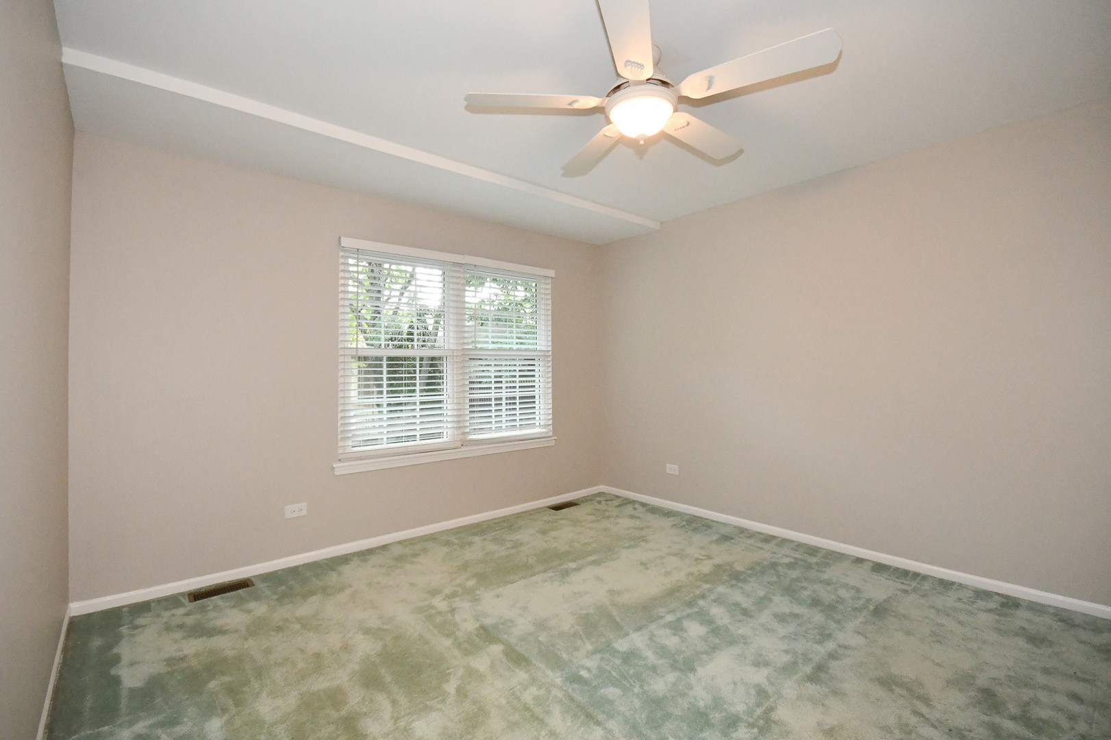 960 Elderberry Circle, Unit 108 Naperville, IL 60563 - Photo 18 of 32 an empty room with a window and a fan