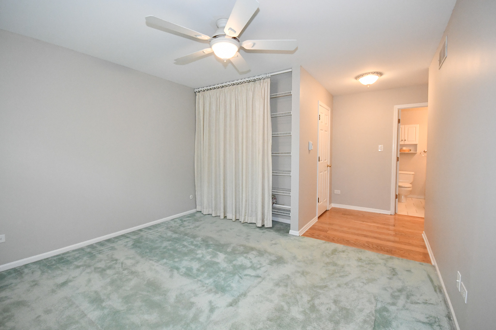 960 Elderberry Circle, Unit 108 Naperville, IL 60563 - Photo 19 of 32 an empty room with closet and a ceiling fan