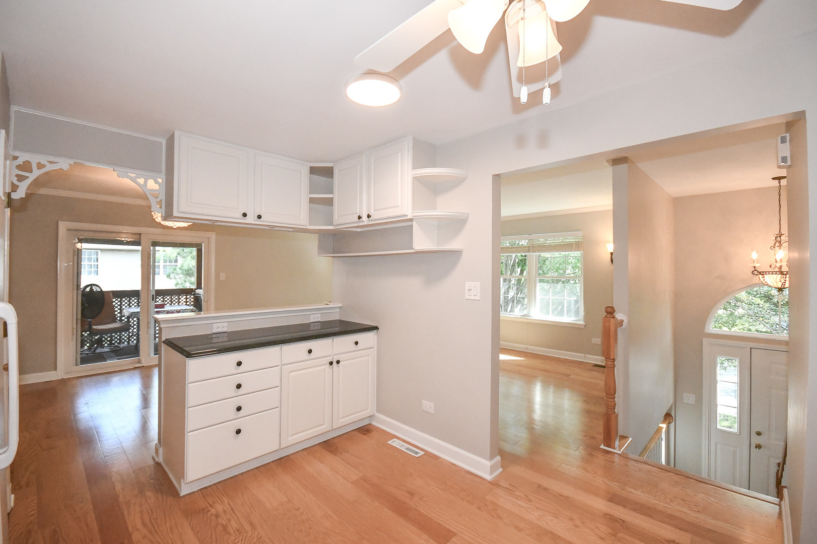 960 Elderberry Circle, Unit 108 Naperville, IL 60563 - Photo 2 of 32 a kitchen with granite countertop a stove a refrigerator and wooden floor