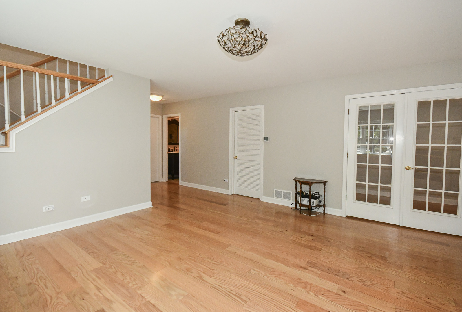 960 Elderberry Circle, Unit 108 Naperville, IL 60563 - Photo 24 of 32 a view of an empty room with a window and wooden floor