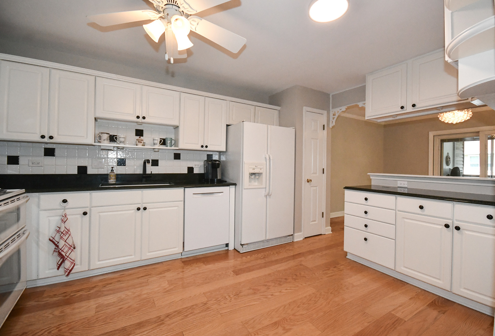 960 Elderberry Circle, Unit 108 Naperville, IL 60563 - Photo 3 of 32 a kitchen with granite countertop white cabinets white stainless steel appliances with a sink and dishwasher