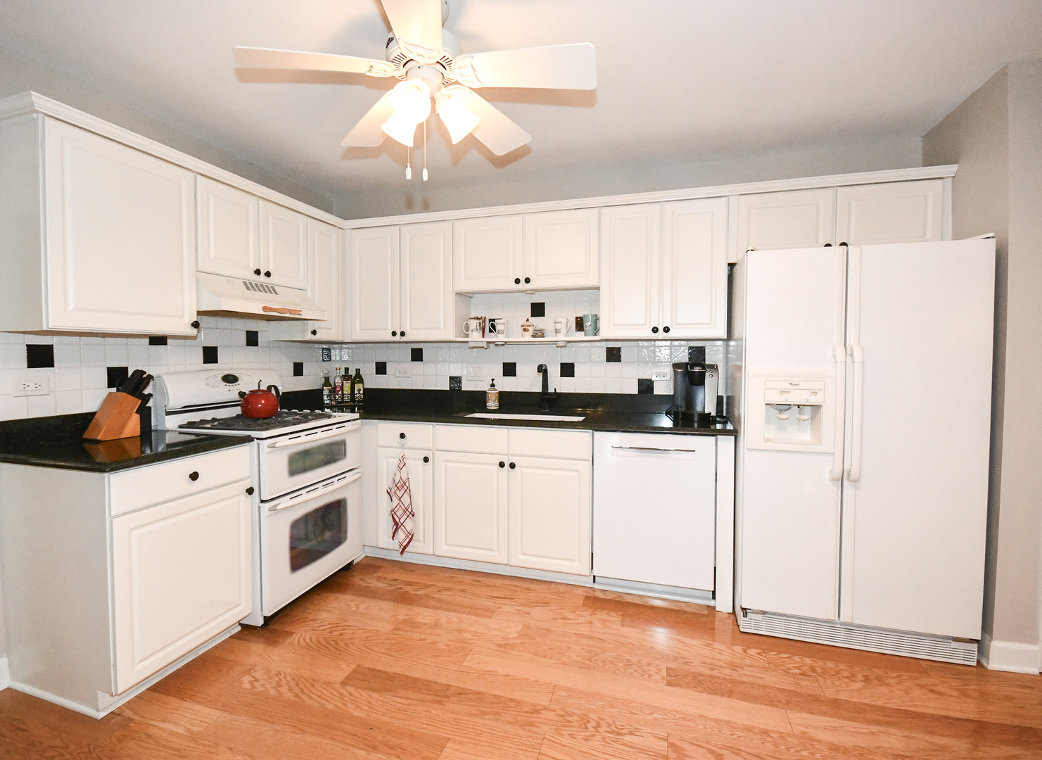 960 Elderberry Circle, Unit 108 Naperville, IL 60563 - Photo 5 of 32 a kitchen with white cabinets and white appliances