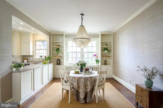 a dining room with furniture window and wooden floor