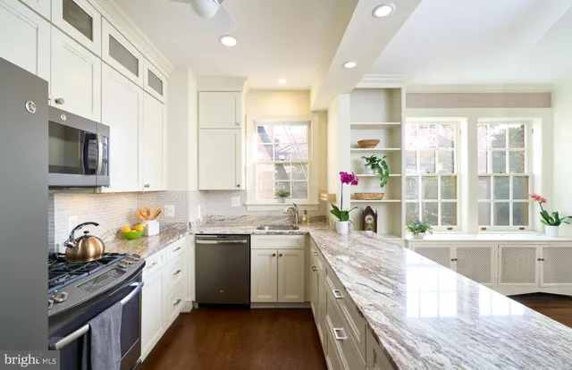 a kitchen with a sink stove top oven and refrigerator