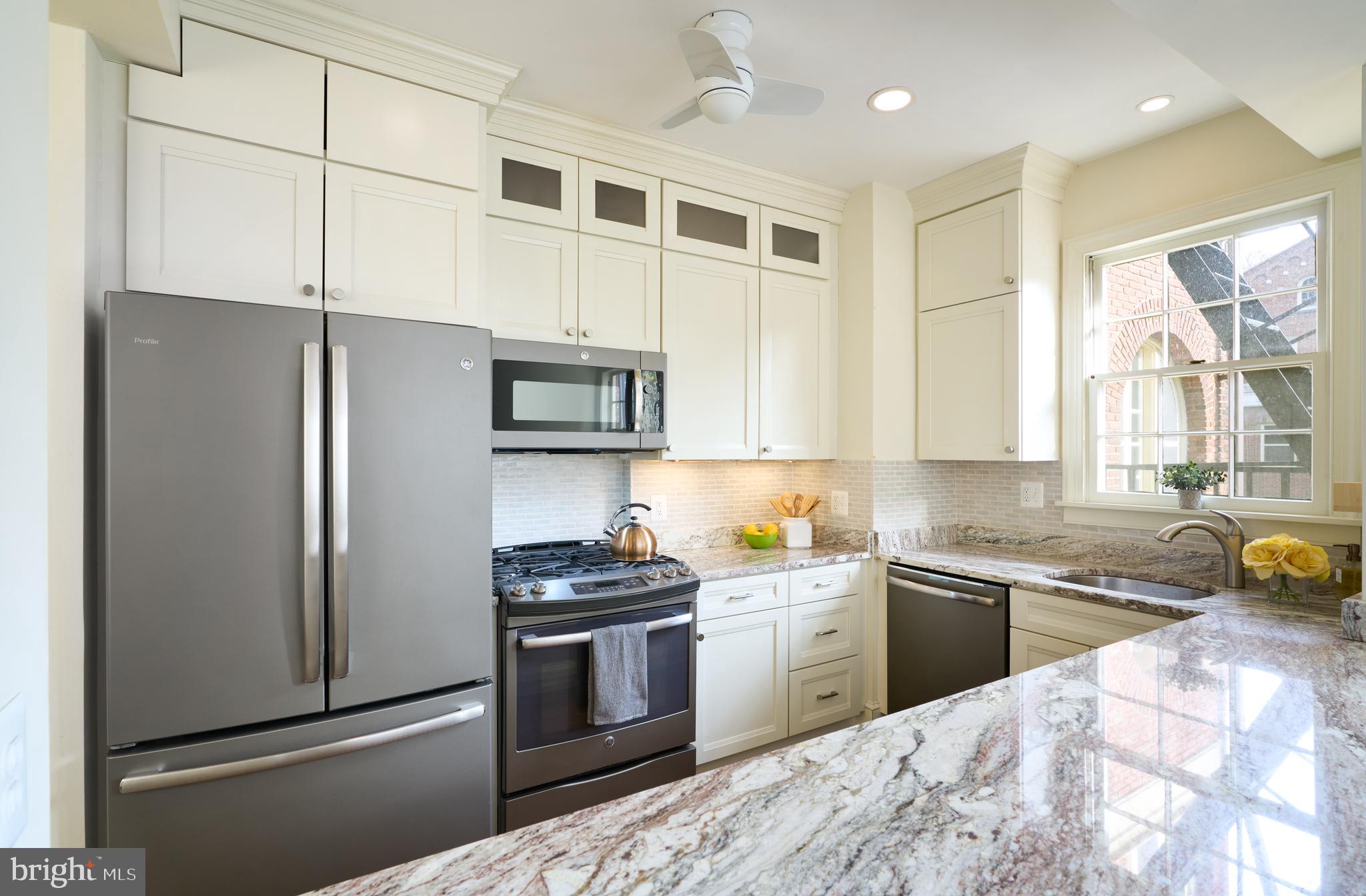 221 Stony Run Lane, Unit J2 Baltimore, MD 21210 - Photo 15 of 31 a kitchen with stainless steel appliances a refrigerator sink and cabinets