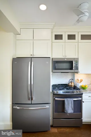 a kitchen with granite countertop stainless steel appliances and wooden cabinets
