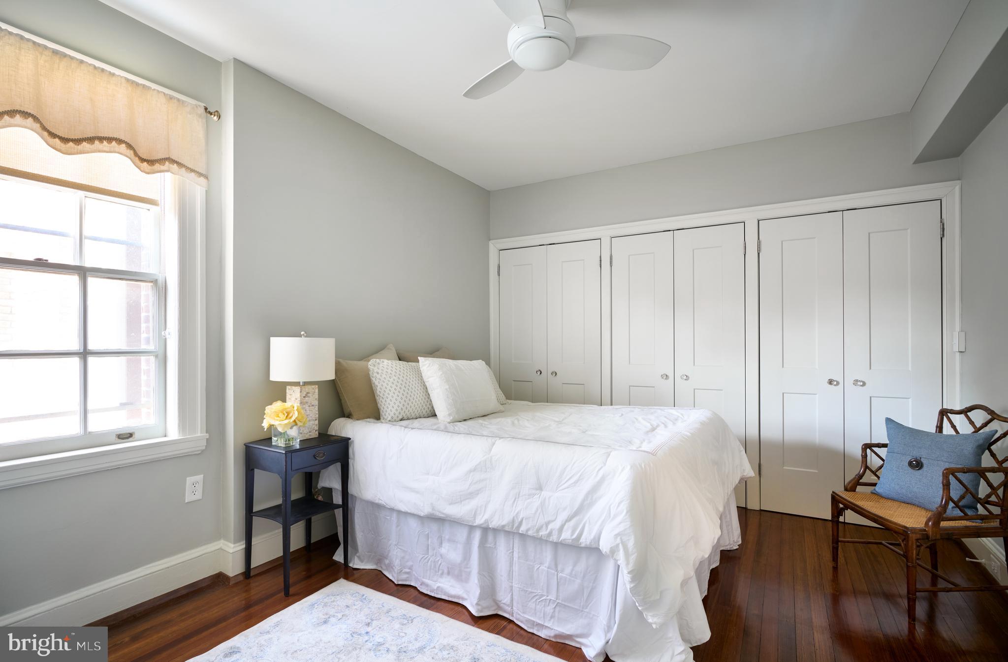 221 Stony Run Lane, Unit J2 Baltimore, MD 21210 - Photo 19 of 31 a bedroom with a bed and wooden floor