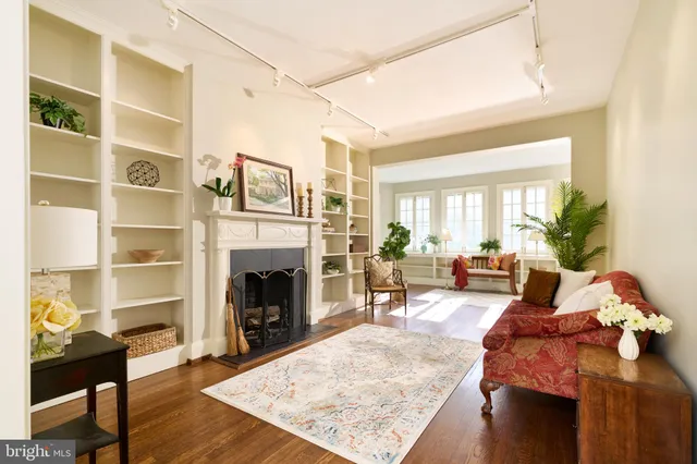 a living room with furniture fireplace and rug